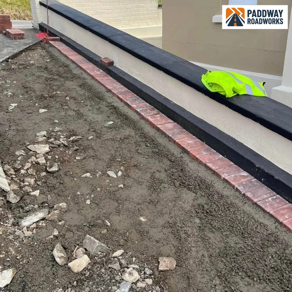 Block paving laid up to a rendered house wall