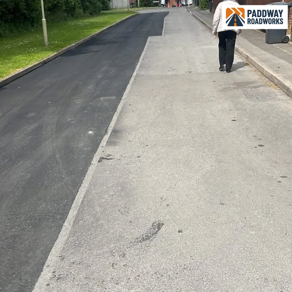 Long tarmac access driveway laid between properties