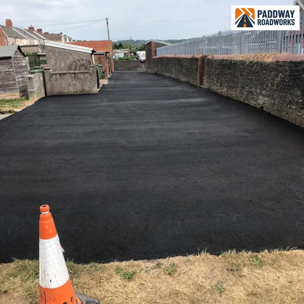 Newly surfaced tarmac forecourt marked out with traffic cones by Paddway Surfacing Solutions